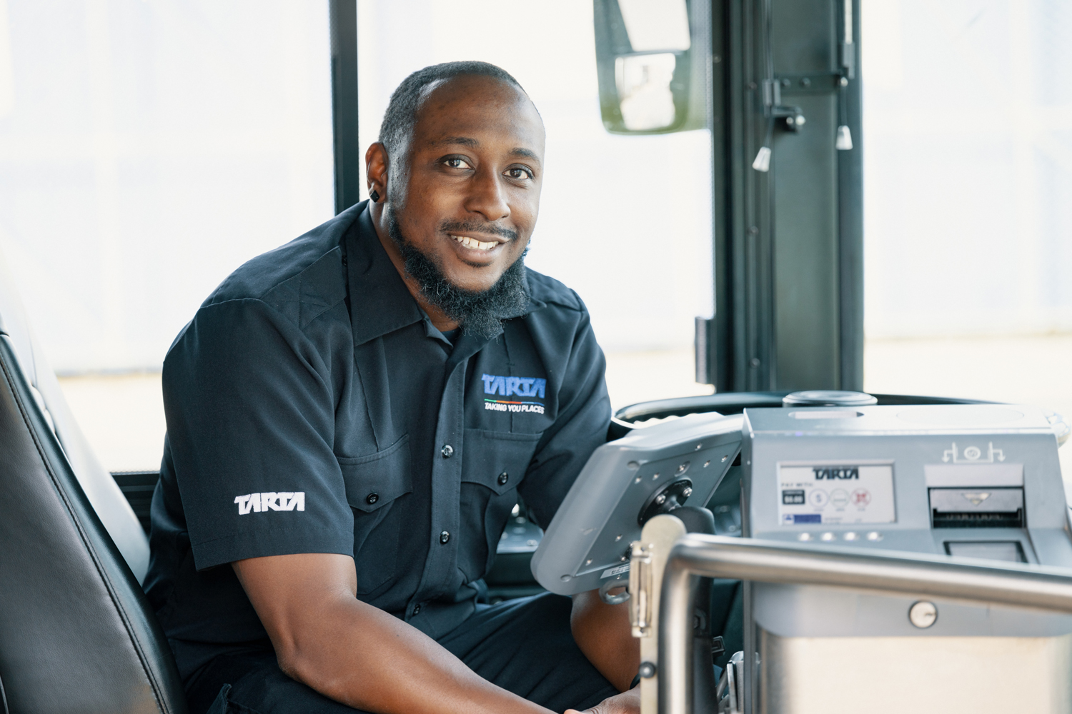 A bus driver smiling