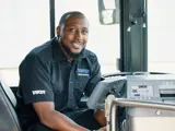 A bus driver smiling